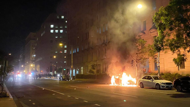 A car on fire one block from the White House as Lafayette Square protests escalate.