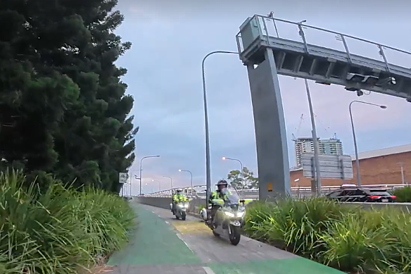 Police riding a motorcycle along the bike lanes of the Go Among Bridge on Thursday, July 2. 