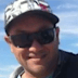 Mel Ismail (left) and the damage done to his board in the shark attack.