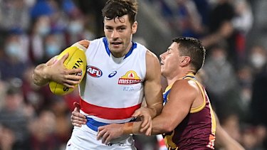Josh Dunkley controls the ball against Dayne Zorko.