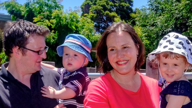 Federal cabinet minister Kelly O'Dwyer posses for a photo with her family after announcing she would not recontest the next election