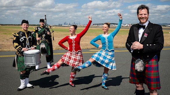 Royal Edinburgh Military Tattoo performers and creative director Alan Lane (right) at Brisbane International Airport.