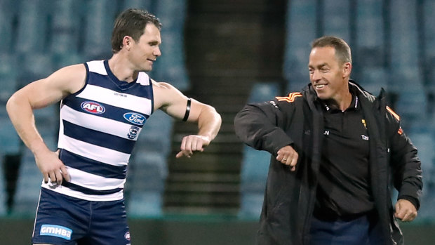 Pandemic protocols: Patrick Dangerfield in his 350th AFL game bumps elbows with Hawks coach Alastair Clarkson. 