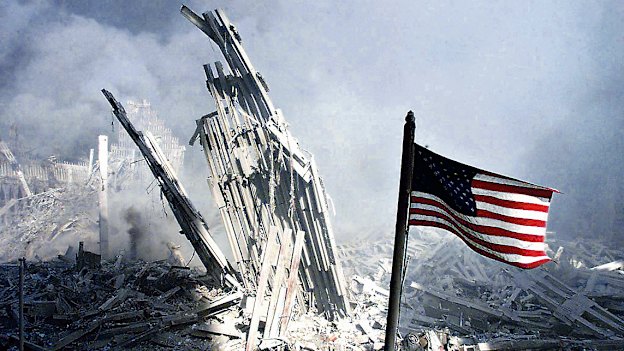 Am American flag flies near the base of the destroyed World Trade Center in New York, September 11, 2001.