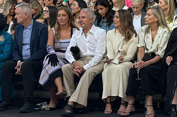 Former Telstra chief executive Andy Penn gets into the spirit of things with wife Kallie Blauhorn at Melbourne Fashion Week.