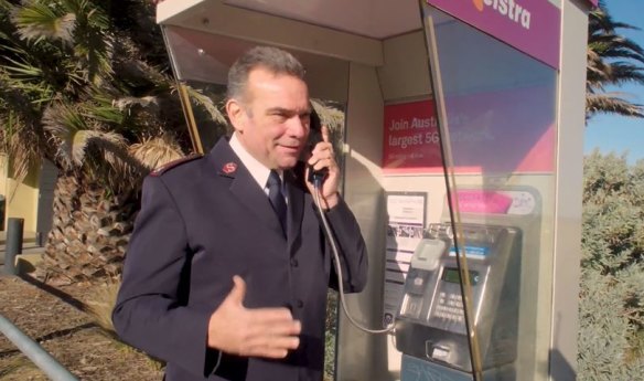 It’s for you: The Salvation Army’s Major Brendan Nottle at a St Kilda payphone.