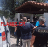 James Dalamangas is led into a police van by Greek authorities.