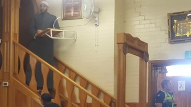 A police officer guards a door at a mosque in Melbourne on Friday afternoon.