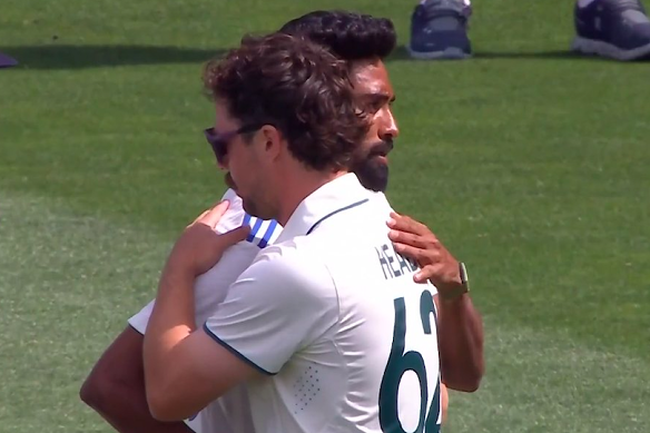 Travis Head and Mohammed Siraj embrace after the Adelaide Test.