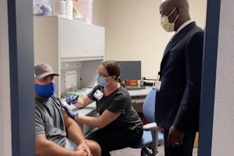 Mark Hall gets the COVID vaccine with the support of Dr Mitchell. 