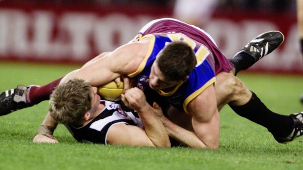 Jason Cloke falls to the ground after marking in front of Jonathon Brown.