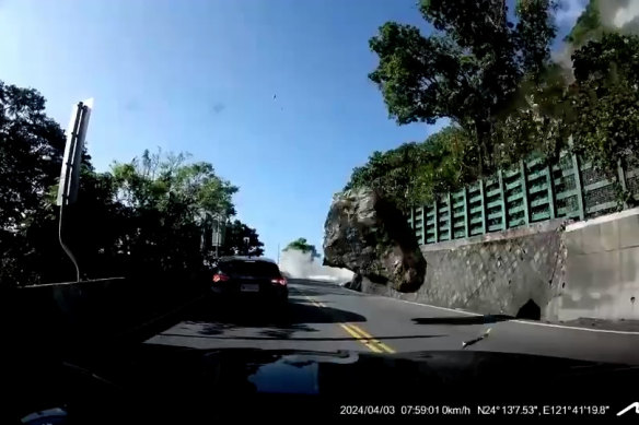 A boulder tumbles toward a car in Taiwan during the earthquake.