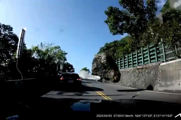 A boulder tumbles toward a car in Taiwan during the earthquake.