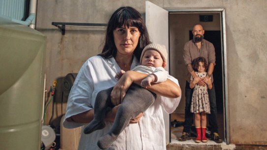 Karri Crossing and Hayden Muirhead  with one-week-old baby Ziggy and daughter Juno; Lismore after the flood peaked on February 28; A Lismore street, days later; A warning sign on a fence of a home along the river in Woodburn.