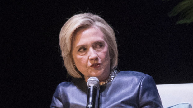 Former President Bill Clinton, left, and Paul Begala, right, listen and former Secretary of State Hillary Rodham Clinton at the Beacon Theatre in New York. 