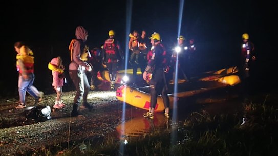 Fire & Rescue NSW crews found snakes in the boats as they rescued a family in Sancrox, NSW.