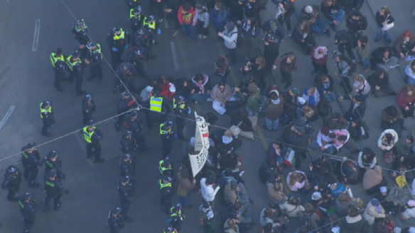 Police move on pro-Palestinian protesters at a rally in Melbourne CBD on Thursday.