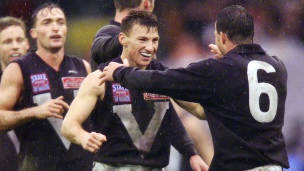 Brent Harvey (centre) hugs Brad Johnson in the 1999 State of Origin game between Victoria and South Australia.