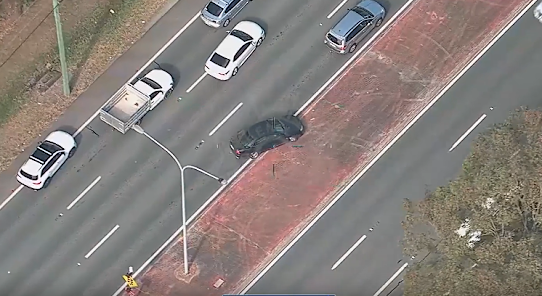 The car crossing a traffic island during the chase.