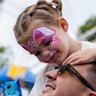 Lola, 2, rests on her father Guy Power’s shoulders, happy with food and facepaint.