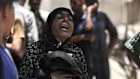 A woman grieves casualties at a humanitarian aid distribution point in Beit Lahia, northern Gaza.