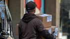 A UPS worker delivers packages in San Francisco. The company said it would cut 20,000 jobs. 