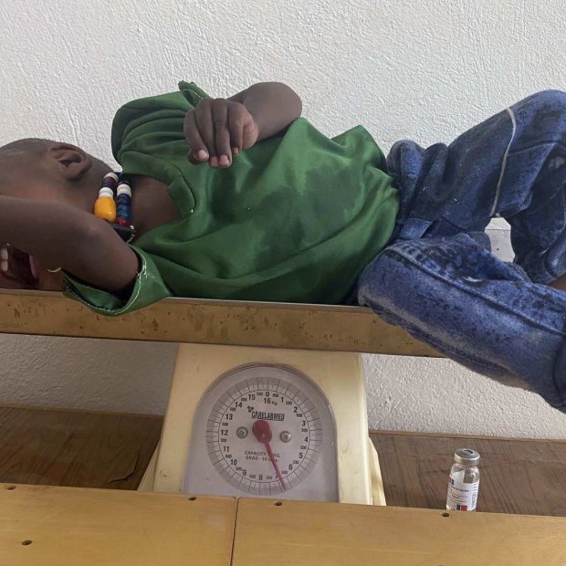 Amanuel Berhanu is weighed after being identified as severely malnourished, in the Wajirat district of the Tigray region of northern Ethiopia on Monday. 