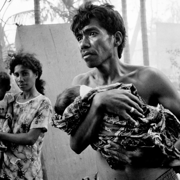 East Timorese return to the burnt out remains of their homes only to find rogue elements with the departing Indonesian Military burning nearby buildings.