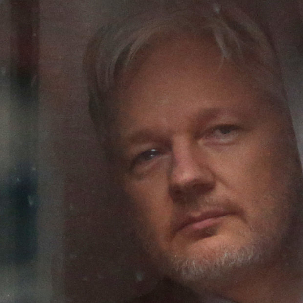 Julian Assange looks out a window of the Ecuadorian embassy in London, where he stayed for nearly seven years.