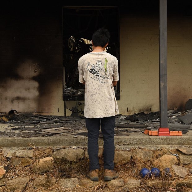 Balmoral resident Gabriel aged 16 looks into what was his bedroom at his home. It was destroyed by fire on December 21.