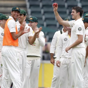 Pat Cummins (second from right) on debut in 2011 after bowling Morne Morkel. 