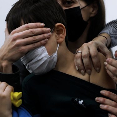Israeli child Liam Lev Tov, 6, in the arms of his mother, receives a Pfizer vaccine. 