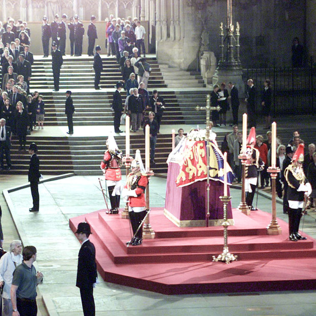 Members of the public file by the coffin of the Queen Mother in Westminster Hall in 2002.