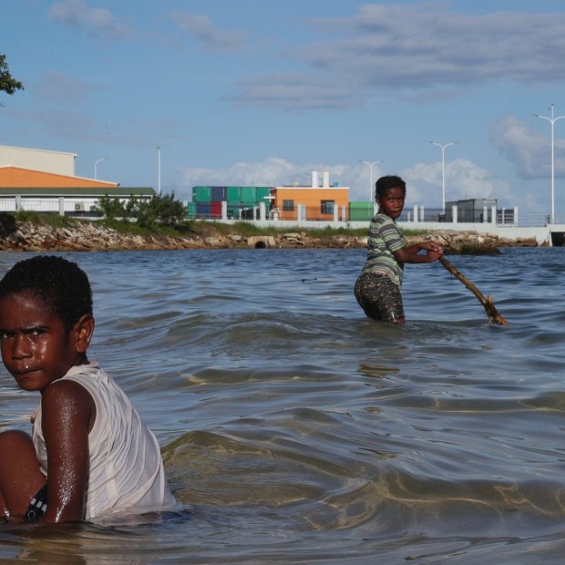 Children play near the new China-funded wharf in Luganville, Vanuatu. 