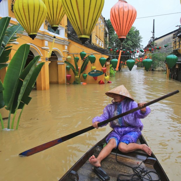 Nguyen Thi Vui in her boat in the flooded streets of Hoi An, Vietnam, in November 2017. 