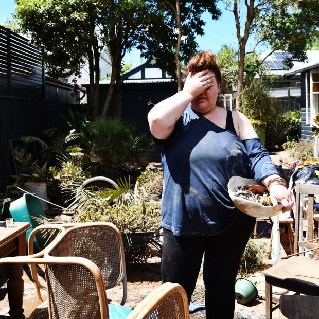 Kym Strow, who lost her business and home during the Lismore floods, with her partner during the long clean-up in March.