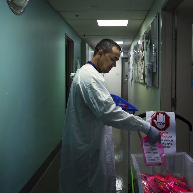 Sanjay Adhikari delivers samples that are to be tested for coronavirus at the Prince of Wales Hospital.  