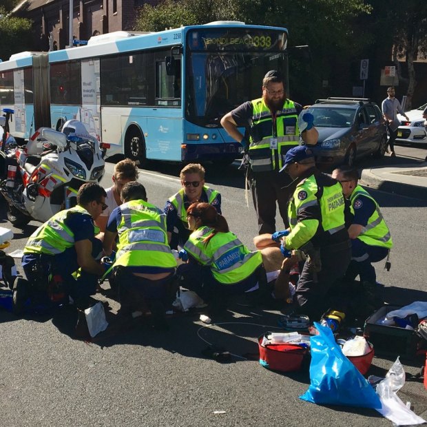 Paramedics attend to Bill Springett-Kelly after his motorbike collision last year in Bondi.