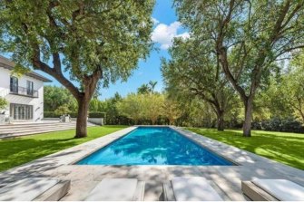 The stunning saltwater lap pool and lounge area is surrounded by oak trees.