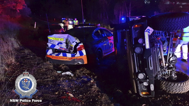 A damaged police car after a Land Rover, right, crashed into it.