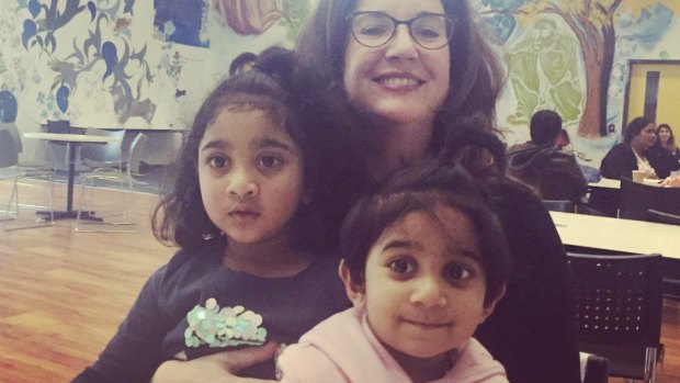 Two Australian-born children of Tamil asylum seekers with journalist Rebekah Holt. The family has been saved from deportation by a last-minute injunction.