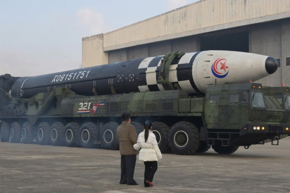 North Korean leader Kim Jong-un and his daughter walk away from an intercontinental ballistic missile in this undated photo released on Saturday.