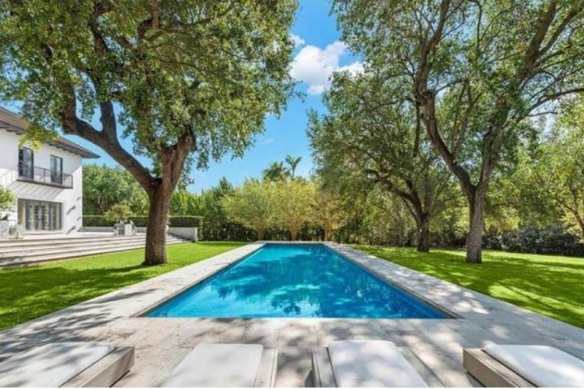 The stunning saltwater lap pool and lounge area is surrounded by oak trees.