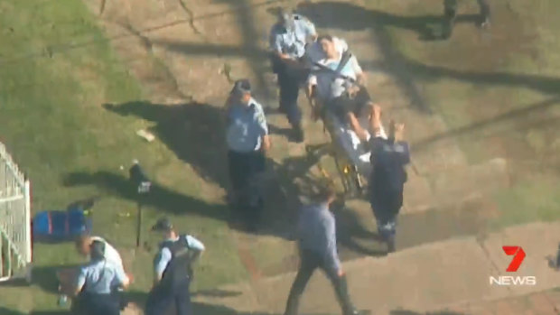 A man was stretchered from the scene as NSW police executed an interstate arrest warrant. 