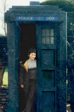 An unearthly child: Australian screenwriter Pete McTighe, aged 8, with the Tardis prop at a Doctor Who exhibition.
