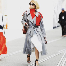 In a Burberry trench coat and Dion Lee jumper and skirt at Australian Fashion Week, 2018.