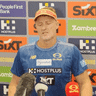 Damien Hardwick delivers a (playful) two-finger salute to the press pack.