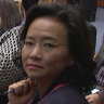 Australian journalist Cheng Lei is “flanked” by two Chinese government officials during a signing ceremony at Parliament House on Monday.