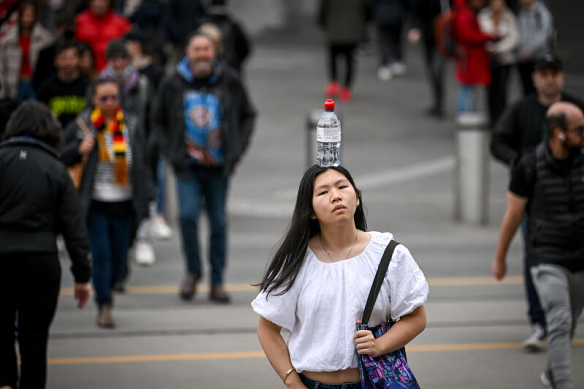 Kelly Huynh finds joy walking with a bottle of water on her head, soaking up smiles as she walks the streets of Melbourne.