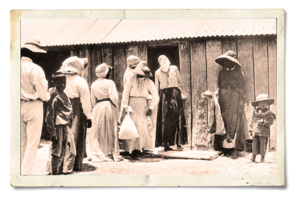 People lining up for flour rations at the Barambah Aboriginal Settlement (now known as Cherbourg) in Queensland in 1911. 